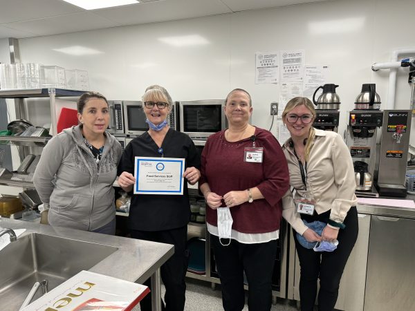 Food Services Staff holding Circle of Gratitude Certificate